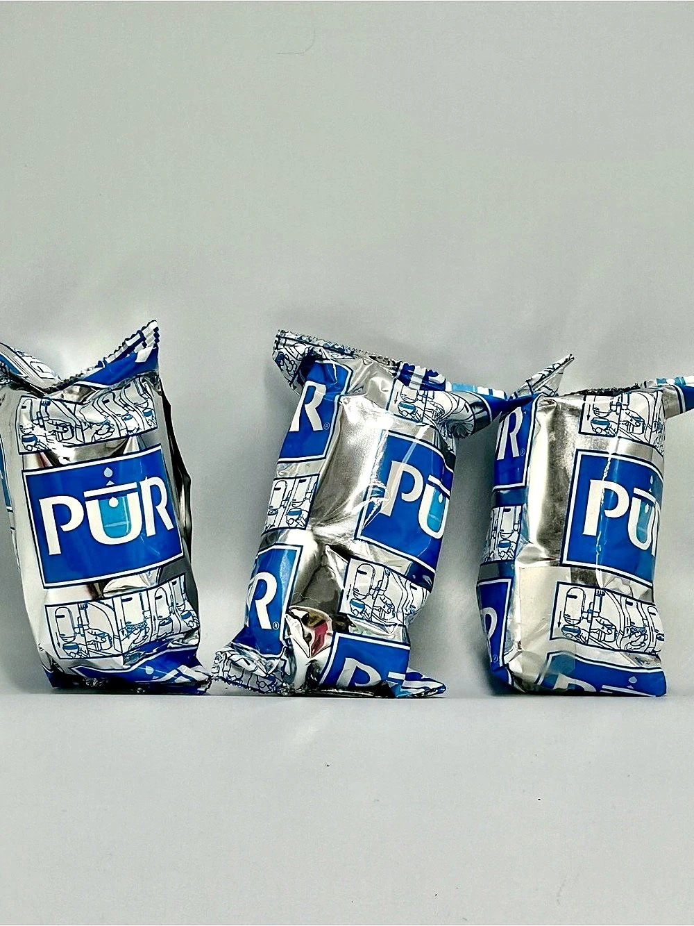 Three packaged PUR Faucet Water Replacement Filters.
